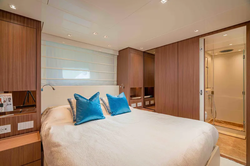 Firefly Yacht Photos Pics Luxurious bedroom interior of 2025 Sanlorenzo SX76 yacht with modern design and blue accents.