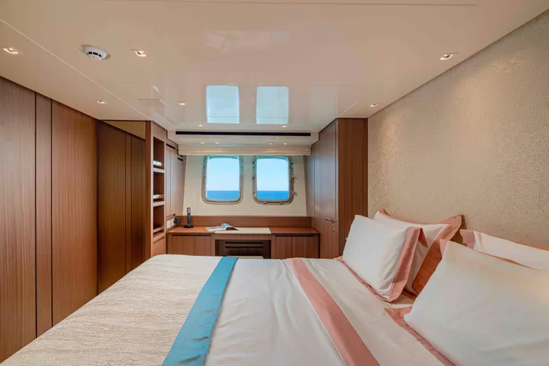 Firefly Yacht Photos Pics Luxurious Sanlorenzo SX76 2025 yacht bedroom with ocean view and elegant wood finishes.