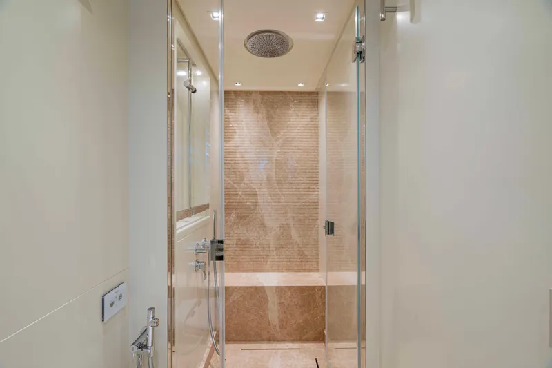 Firefly Yacht Photos Pics Luxurious bathroom interior on 2025 Sanlorenzo SX76 yacht, featuring elegant shower design.
