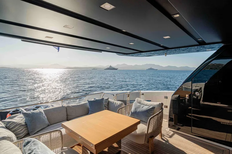 Firefly Yacht Photos Pics Luxurious 2025 Sanlorenzo SX76 yacht deck with ocean view and comfortable seating.