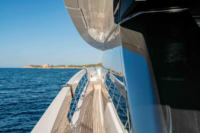 Firefly Yacht Photos Pics 2025 Sanlorenzo SX76 yacht cruising on open sea with scenic coastal view.