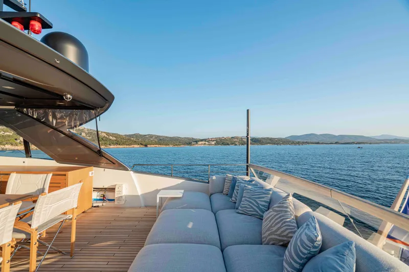 Firefly Yacht Photos Pics Luxurious 2025 Sanlorenzo SX76 yacht deck with ocean view and comfortable seating.