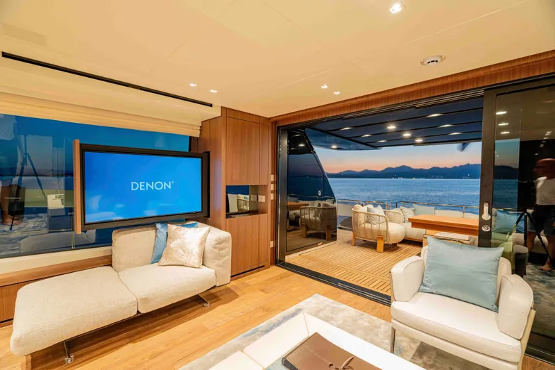 Firefly Yacht Photos Pics Luxurious interior of 2025 Sanlorenzo SX76 yacht with ocean view and modern furnishings.