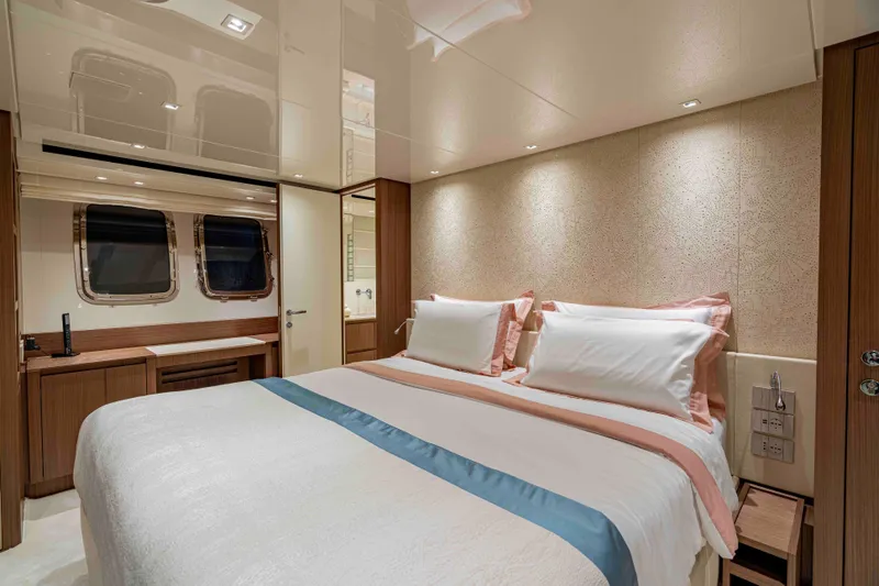 Firefly Yacht Photos Pics Luxurious bedroom interior of 2025 Sanlorenzo SX76 yacht with elegant bedding and modern design.