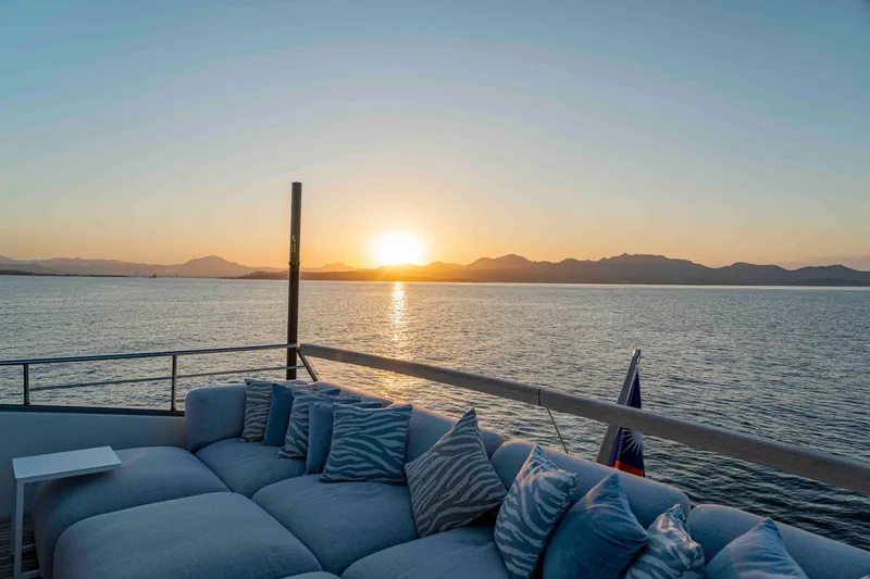 Firefly Yacht Photos Pics Luxurious Sanlorenzo SX76 yacht deck with sunset view over the ocean, 2025 model.