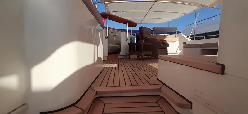 An Yacht Photos Pics Luxurious 1997 Vitters Motoryacht deck with wooden flooring and seating area.
