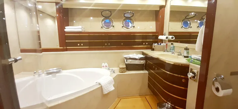 An Yacht Photos Pics Luxurious bathroom in a 1997 Vitters motoryacht with elegant wood accents and porthole windows.