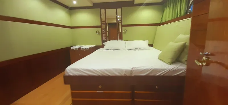 An Yacht Photos Pics Luxurious bedroom interior of 1997 Vitters Motoryacht with green walls and wooden accents.