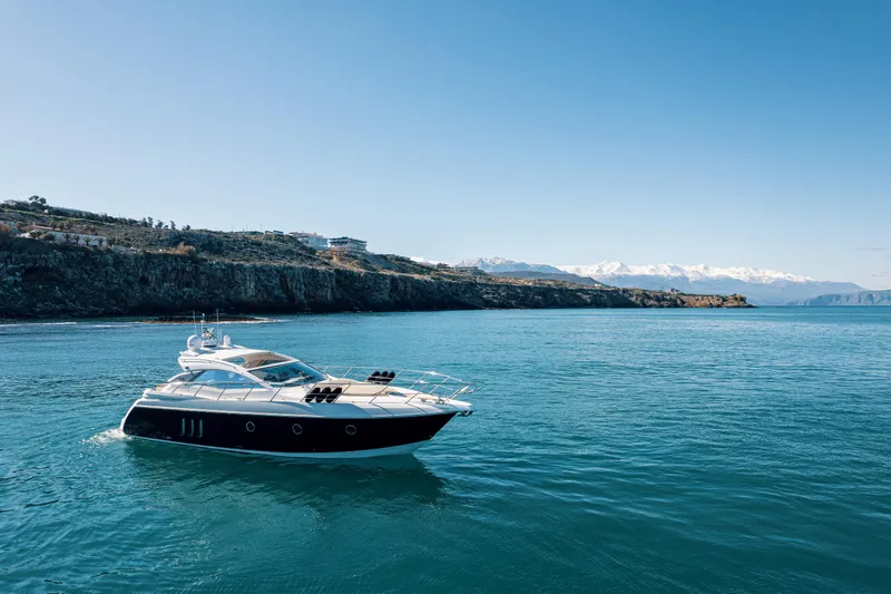  Yacht Photos Pics 2008 Sessa Marine C46 yacht cruising on a serene blue sea with scenic coastal backdrop.