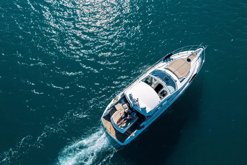  Yacht Photos Pics Aerial view of 2008 Sessa Marine C46 yacht cruising on clear blue water.