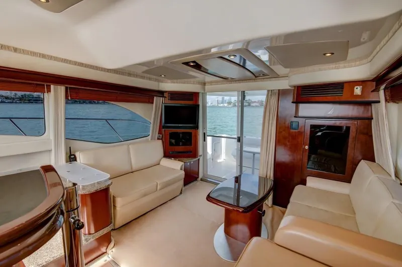 Jody Yacht Photos Pics Luxurious interior of 2006 Sea Ray 44 Sedan Bridge yacht with elegant seating and panoramic windows.