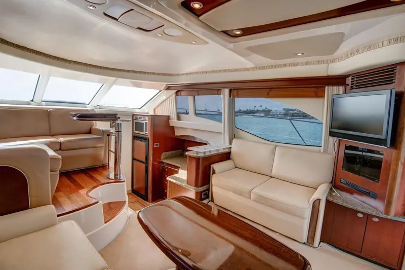 Jody Yacht Photos Pics Luxurious interior of 2006 Sea Ray 44 Sedan Bridge yacht with elegant seating and panoramic windows.