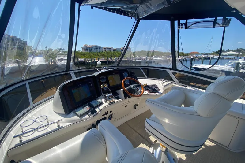Jody Yacht Photos Pics 2006 Sea Ray 44 Sedan Bridge helm with modern controls and marina view.