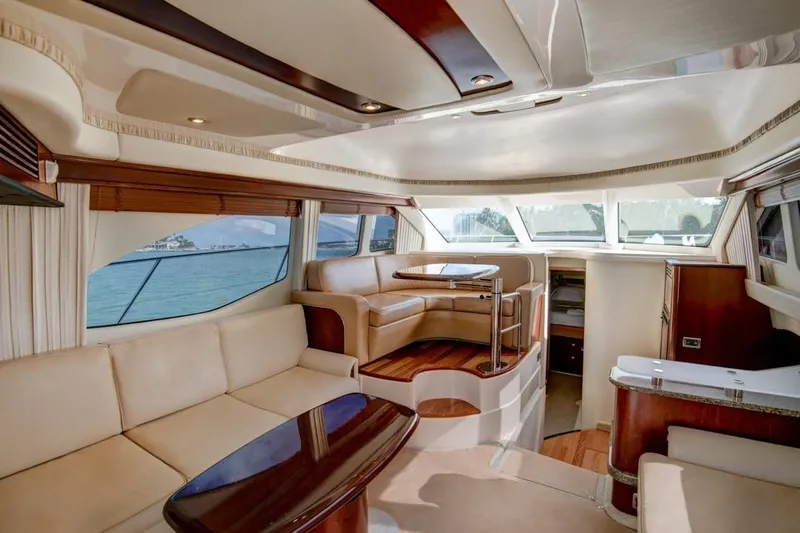 Jody Yacht Photos Pics Luxurious interior of 2006 Sea Ray 44 Sedan Bridge yacht with elegant seating and panoramic windows.