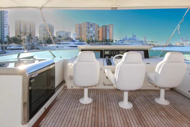 My Way Victoria Yacht Photos Pics Luxury yacht helm on 2007 Dominator 860 Fly, overlooking marina and cityscape.