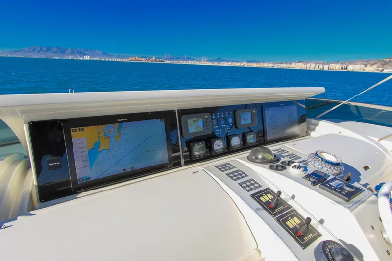 My Way Victoria Yacht Photos Pics Cockpit view of 2007 Dominator 860 Fly yacht with navigation screens and controls.