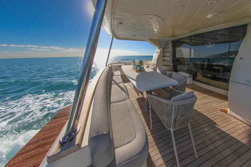 My Way Victoria Yacht Photos Pics Luxurious 2007 Dominator 860 Fly yacht deck with ocean view and elegant seating area.