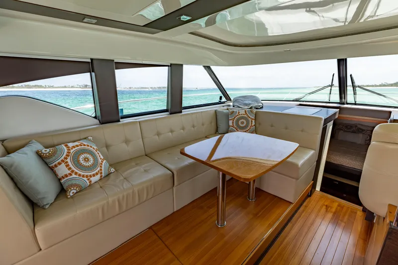 Silver Lining Yacht Photos Pics Luxurious interior of 2015 Tiara Yachts 44 Coupe with elegant seating and ocean view.