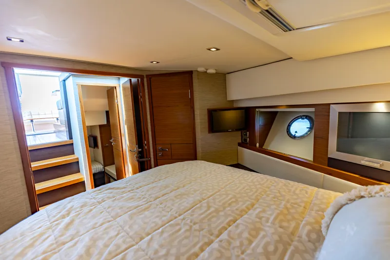 Silver Lining Yacht Photos Pics Luxurious bedroom interior of 2015 Tiara Yachts 44 Coupe with modern amenities.