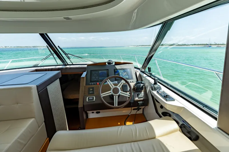 Silver Lining Yacht Photos Pics Interior view of 2015 Tiara Yachts 44 Coupe helm with ocean backdrop.