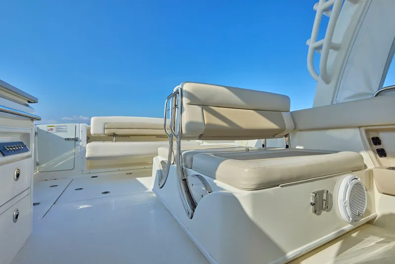 Hitm Yacht Photos Pics 2016 Boston Whaler 320 Vantage boat interior with cushioned seating and clear blue sky.