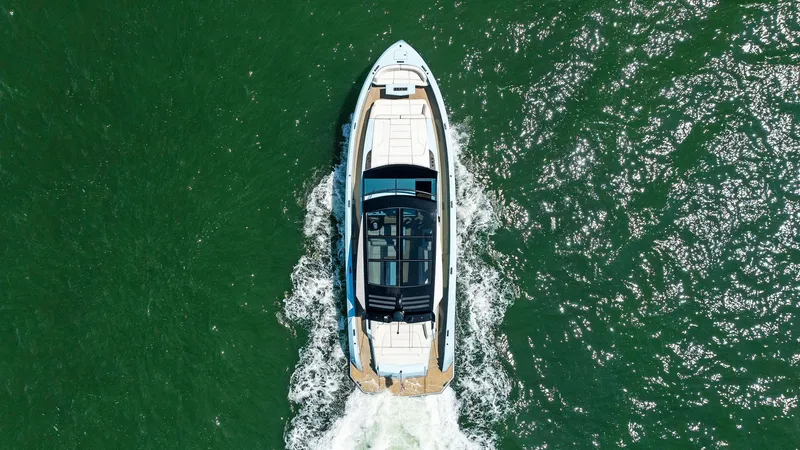 Shaloha Yacht Photos Pics Aerial view of 2022 Vanquish Yachts VQ58 cruising on green water.