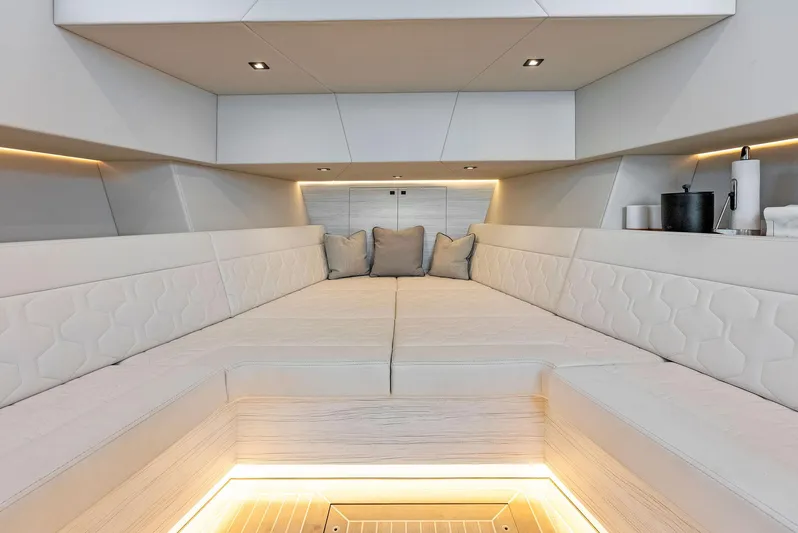 Shaloha Yacht Photos Pics Luxurious interior of 2022 Vanquish Yachts VQ58 with modern white seating and ambient lighting.