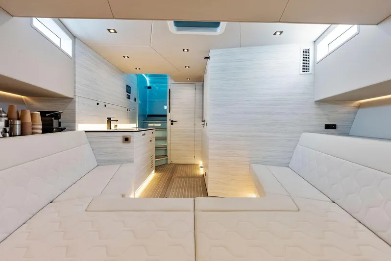 Shaloha Yacht Photos Pics Interior of 2022 Vanquish Yachts VQ58, featuring modern white seating and sleek design.