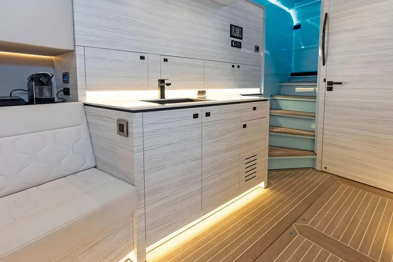 Shaloha Yacht Photos Pics Modern interior of 2022 Vanquish Yachts VQ58 with sleek kitchen and ambient lighting.