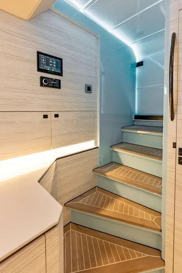 Shaloha Yacht Photos Pics Modern interior staircase of 2022 Vanquish Yachts VQ58 with ambient lighting.
