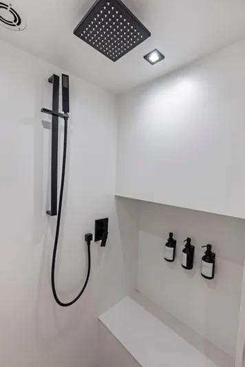 Shaloha Yacht Photos Pics Modern shower area in 2022 Vanquish Yachts VQ58 with sleek fixtures and built-in toiletries.