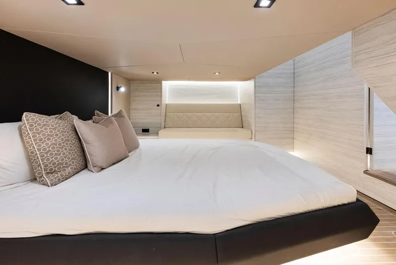 Shaloha Yacht Photos Pics Luxurious bedroom interior of 2022 Vanquish Yachts VQ58 with modern design and cozy bedding.
