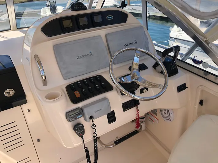  Yacht Photos Pics 2009 Grady-White CHESAPEAKE boat helm with Garmin navigation system and steering wheel.