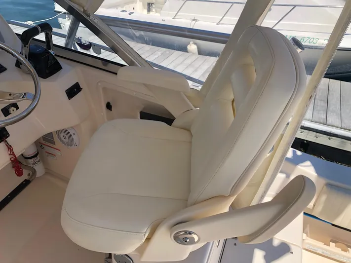  Yacht Photos Pics 2009 Grady-White CHESAPEAKE boat interior with white captain's chair and steering wheel.