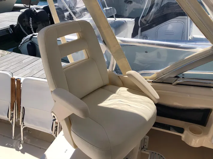  Yacht Photos Pics Captain's chair on 2009 Grady-White CHESAPEAKE boat, docked with clear canopy.