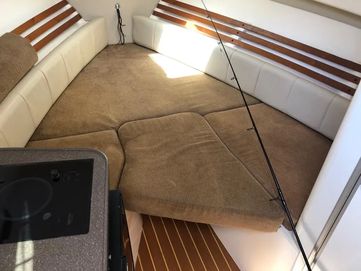  Yacht Photos Pics Interior of 2009 Grady-White CHESAPEAKE boat with cushioned seating and fishing rod.