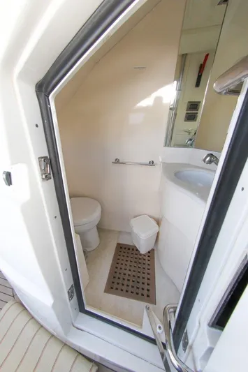 My Way Victoria Yacht Photos Pics Compact bathroom on 2007 Dominator 860 Fly yacht, featuring toilet and sink.