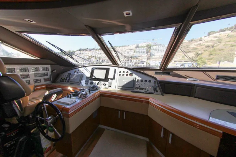 My Way Victoria Yacht Photos Pics Cockpit of 2007 Dominator 860 Fly yacht with modern navigation equipment and panoramic windows.