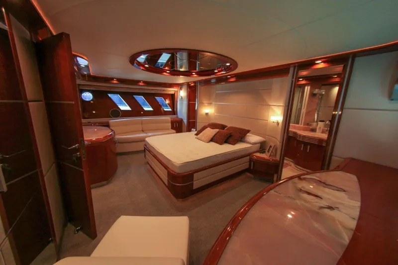 My Way Victoria Yacht Photos Pics Luxurious bedroom interior of 2007 Dominator 860 Fly yacht with elegant wood finishes.