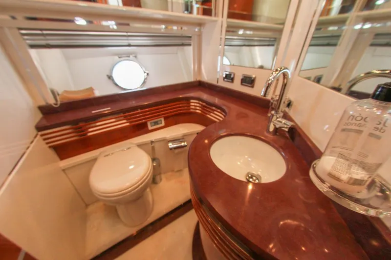 My Way Victoria Yacht Photos Pics Luxurious bathroom in 2007 Dominator 860 Fly yacht with elegant fixtures and porthole window.