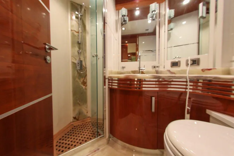 My Way Victoria Yacht Photos Pics Luxurious bathroom interior of 2007 Dominator 860 Fly yacht with wood accents and glass shower.