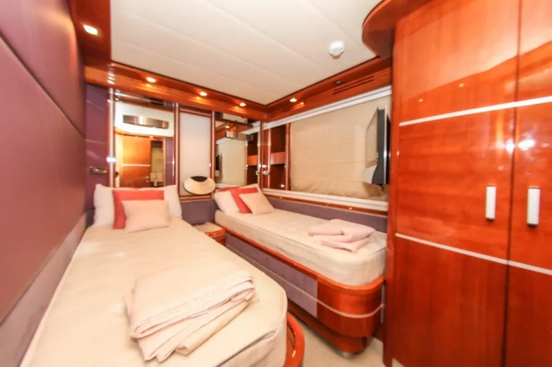 My Way Victoria Yacht Photos Pics Luxurious cabin interior of 2007 Dominator 860 Fly yacht with twin beds and elegant wood finish.