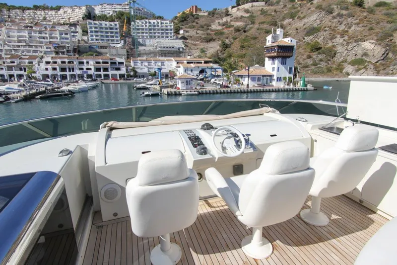 My Way Victoria Yacht Photos Pics Flybridge of 2007 Dominator 860 Fly yacht overlooking marina and hillside buildings.