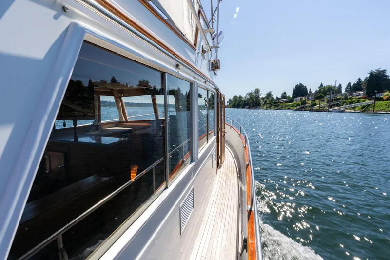 Celebration Yacht Photos Pics 1988 Grand Banks 42 Classic yacht cruising on a sunny, scenic waterway.
