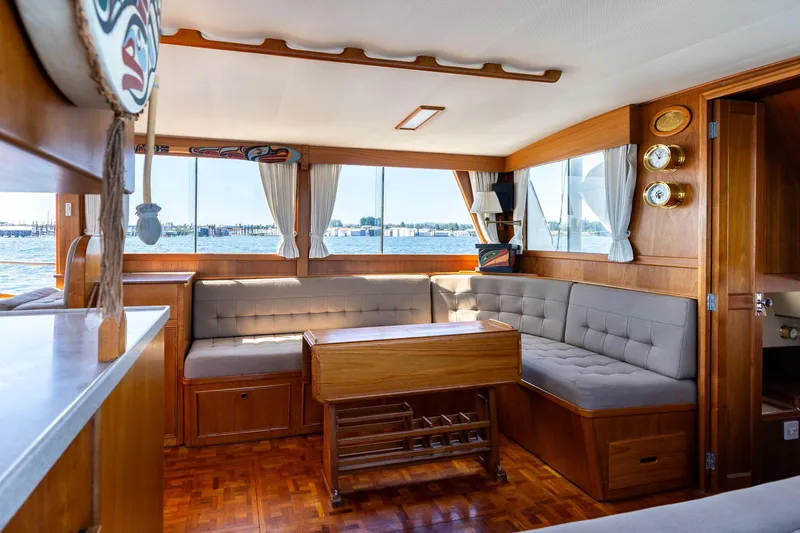 Celebration Yacht Photos Pics Interior of 1988 Grand Banks 42 Classic yacht with wood paneling and cushioned seating.