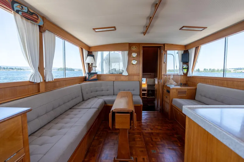 Celebration Yacht Photos Pics Interior of 1988 Grand Banks 42 Classic yacht with wood finish and panoramic windows.