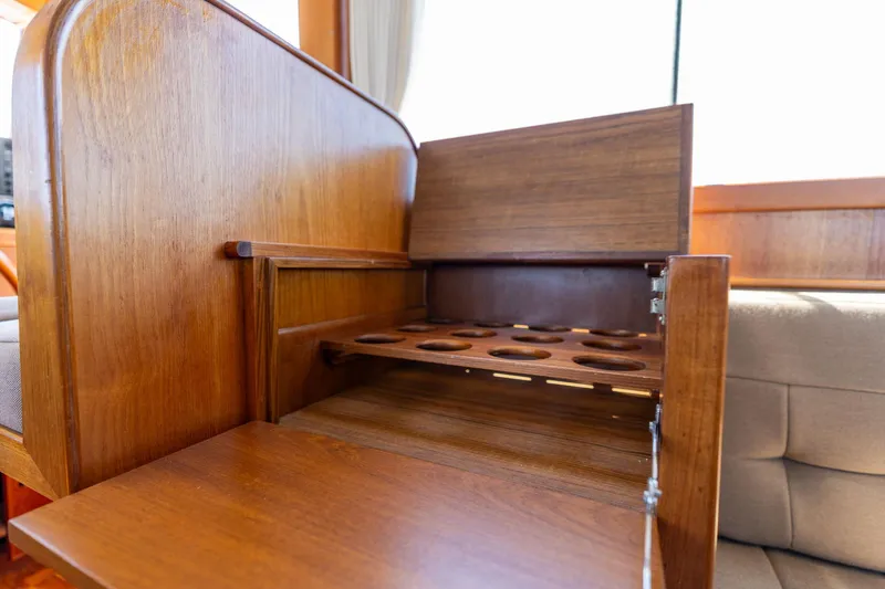 Celebration Yacht Photos Pics Wooden interior detail of 1988 Grand Banks 42 Classic yacht, featuring a built-in storage compartment.