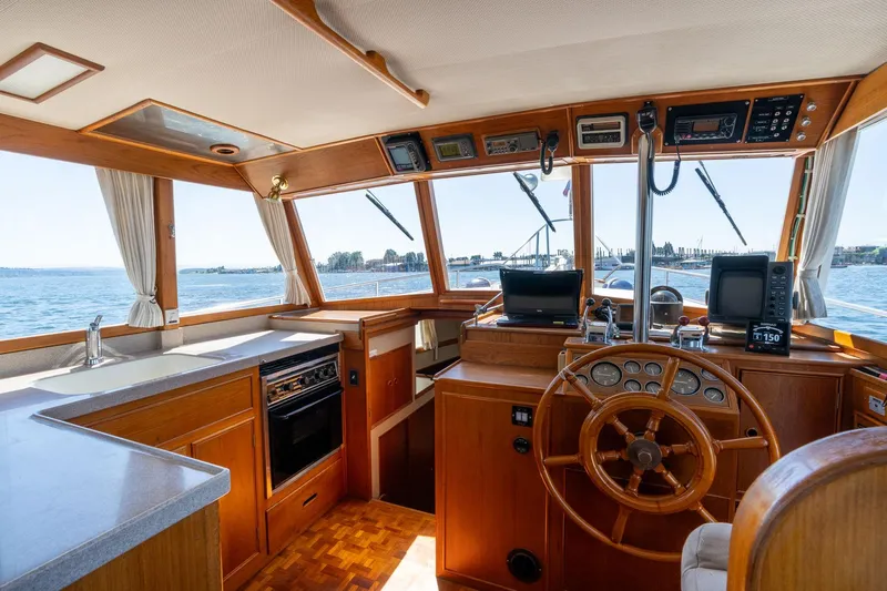 Celebration Yacht Photos Pics Interior of 1988 Grand Banks 42 Classic yacht with helm, kitchen, and ocean view.