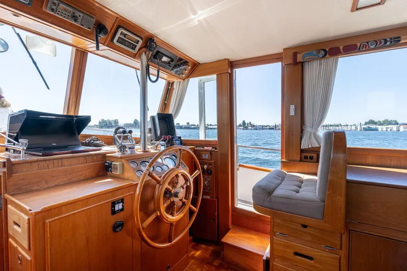 Celebration Yacht Photos Pics Interior of 1988 Grand Banks 42 Classic yacht with wooden helm and ocean view.