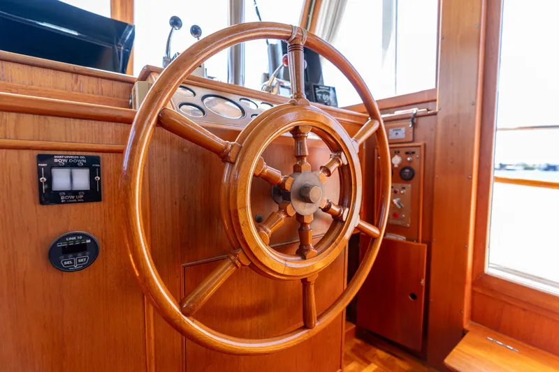 Celebration Yacht Photos Pics Wooden helm of a 1988 Grand Banks 42 Classic yacht, showcasing classic nautical design.